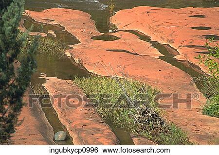 High angle view of a stream flowing into a river View Large Photo Image Stock Photograph - High angle view of a stream flowing into a river. Fotosearch