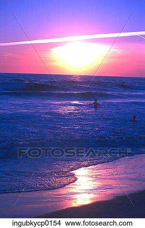 High angle view of people in the sea at dusk View Large Photo Image Picture - High angle view of people in the sea at dusk. Fotosearch