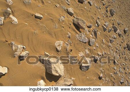 High angle view of stones embedded in sand View Large Photo Image Stock Photo - High angle view of stones embedded in sand. Fotosearch