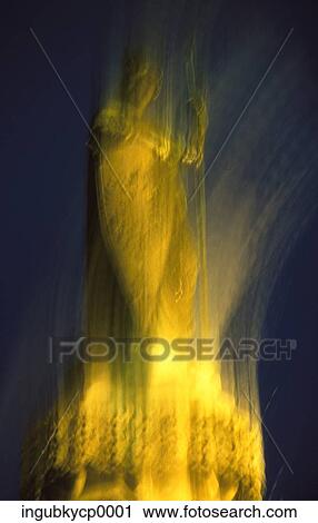 Stock Image - Low angle view of a statue on a pedestal. Fotosearch