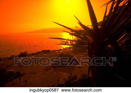 Stock Photo - Panoramic view of the beach at dusk. Fotosearch