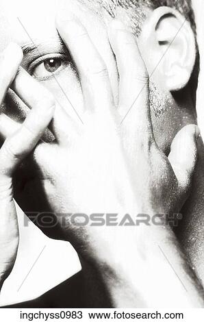 Stock Image - finger, mischief, Young Adult, close up, Looking at Camera. Fotosearch