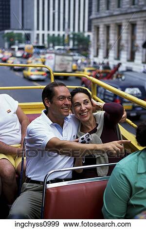 Stock Photo - group, men, double decker, public, away, clothing. Fotosearch