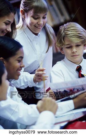 Stock Photo - group, people, learning, boys, girls, looking down, uniform. Fotosearch