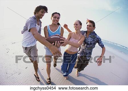 Picture - group, sand, smile, blond, long, short, barefoot. Fotosearch