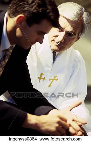 Picture - men, talking, conversation, religious, cross, religion, advice. Fotosearch