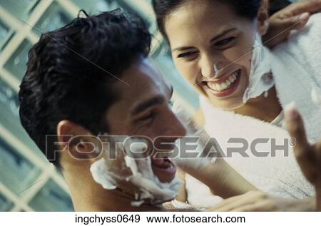 Stock Photo - men, women, romance, play, looking down, shaving, shaving cream. Fotosearch