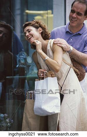 men, women, stand, shop, looking down, clothing, shopping bag View Large Photo Image Stock Image - men, women, stand, shop, looking down, clothing, shopping bag. Fotosearch