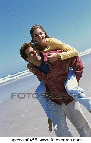 people, couple, beach, clothed, Young Adult View Large Photo Image Stock Photograph - people, couple, beach, clothed, Young Adult. Fotosearch