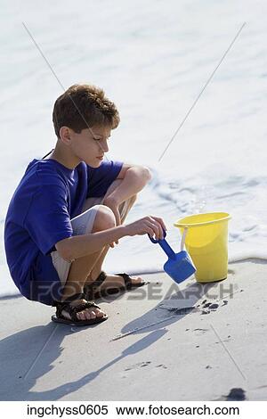 people, water, beach, boy, shovel, tide, shore View Large Photo Image Stock Photography - people, water, beach, boy, shovel, tide, shore. Fotosearch