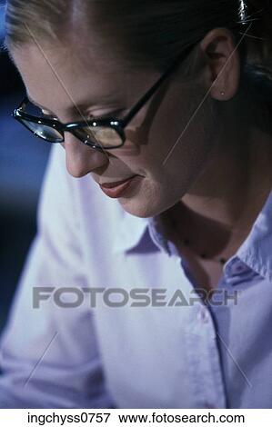 people, woman, eyeglasses, concentration, reading, concentrating, brunette View Large Photo Image Stock Photo - people, woman, eyeglasses, concentration, reading, concentrating, brunette. Fotosearch