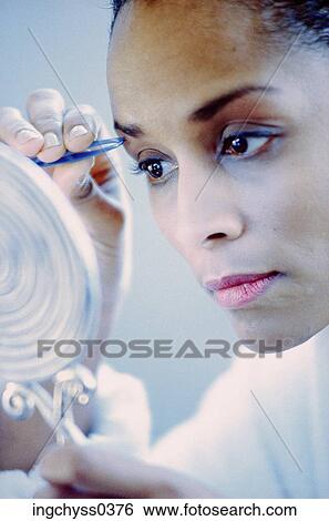 people, woman, face, watch, concentrating, mirror, watching View Large Photo Image Stock Photograph - people, woman, face, watch, concentrating, mirror, watching. Fotosearch