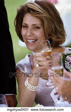 Stock Image - people, woman, formal, smiling, glasses, toasting, wine. Fotosearch