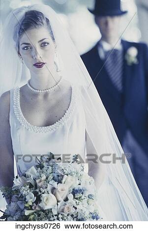 Stock Photograph - people, woman, portrait, front, veil, hold, bride. Fotosearch