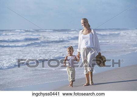 Stock Image - sand, women, family, child, blond, pants, barefoot. Fotosearch