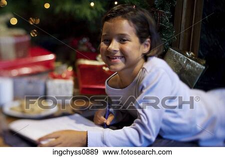 Stock Photo - smiling, excited, Christmas, happy, girl, Christmas tree, presents. Fotosearch