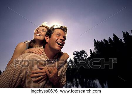 tree, sky, clothing, piggyback, happiness, casual, togetherness View Large Photo Image Stock Photograph - tree, sky, clothing, piggyback, happiness, casual, togetherness. Fotosearch