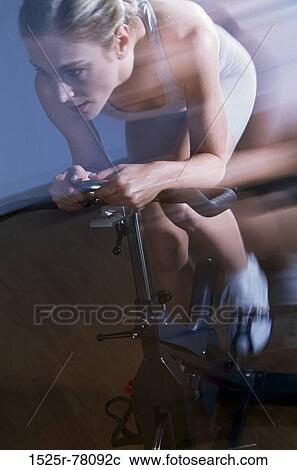 Stock Image - blur, woman, motion, health, sports, exercise, bike. Fotosearch