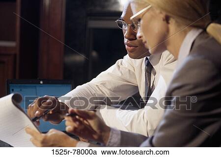 Businessman and a businesswoman in a meeting View Large Photo Image Stock Image - Businessman and a businesswoman in a meeting. Fotosearch