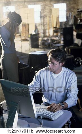 Businessman and a businesswoman working in an office View Large Photo Image Stock Image - Businessman and a businesswoman working in an office. Fotosearch