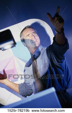 Businessman giving a presentation in a meeting View Large Photo Image Stock Image - Businessman giving a presentation in a meeting. Fotosearch