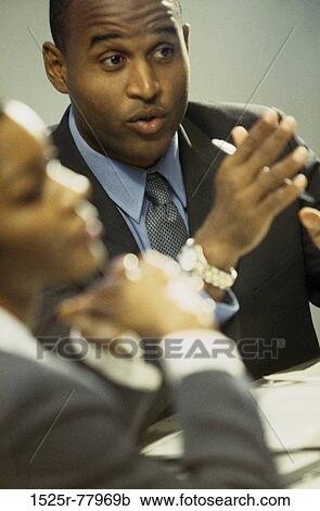 Businesswoman and a businessman in a meeting View Large Photo Image Stock Image - Businesswoman and a businessman in a meeting. Fotosearch