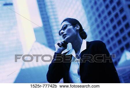 Businesswoman talking on a mobile phone View Large Photo Image Stock Image - Businesswoman talking on a mobile phone. Fotosearch