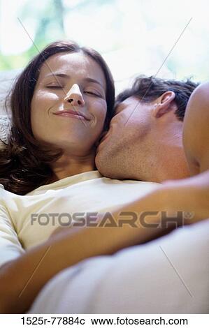 Close-up of young man kissing a young woman in bed View Large Photo Image Stock Image - Close-up of young man kissing a young woman in bed. Fotosearch