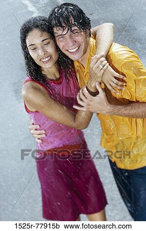 High angle view of a young couple standing in the rain View Large Photo Image Stock Image - High angle view of a young couple standing in the rain. Fotosearch