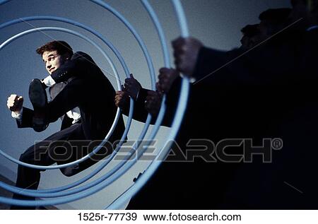 Stock Photo - jump, jumping, business, trapped, indoors, hoops. Fotosearch