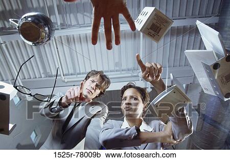 Low angle view of a businessman and a businesswoman View Large Photo Image Stock Image - Low angle view of a businessman and a businesswoman. Fotosearch