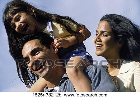 Low angle view of parents with their daughter View Large Photo Image Stock Image - Low angle view of parents with their daughter. Fotosearch