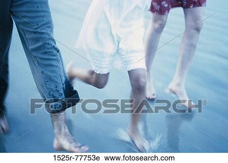Low section view of a couple on the beach with their daughter View Large Photo Image Stock Image - Low section view of a couple on the beach with their daughter. Fotosearch