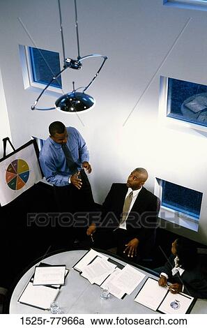 Stock Image - meeting, group, talking, presentation, business, Middle-aged, explaining. Fotosearch