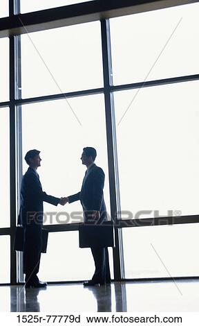 Stock Image - men, hands, windows, deal, silhouette, business, shaking. Fotosearch