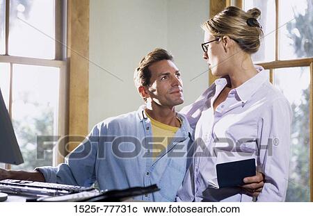 Mid adult couple talking View Large Photo Image Stock Image - Mid adult couple talking. Fotosearch