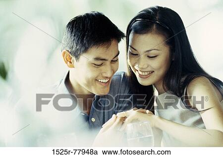 Stock Image - people, Asian, couple, romantic, jewelry, looking. Fotosearch
