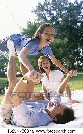 Stock Image - people, balance, smiling, playing, laughing, holding, playful. Fotosearch