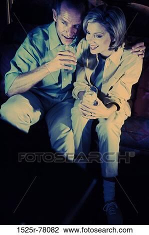 people, couple, drinking, entertainment, Middle-aged, television, blond View Large Photo Image Stock Image - people, couple, drinking, entertainment, Middle-aged, television, blond. Fotosearch