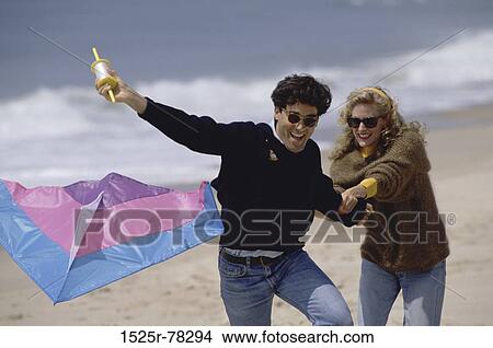 people, couple, flying, beach, laughing, sunglasses, playful View Large Photo Image Picture - people, couple, flying, beach, laughing, sunglasses, playful. Fotosearch