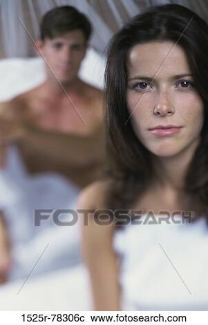 Stock Image - people, home, couple, bed, brunette, indoors. Fotosearch