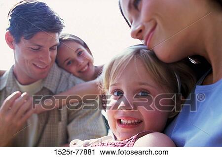 Stock Image - people, smiling, happy, outdoors, nurturing, family. Fotosearch