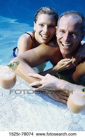 people, swim, pool, smiling, couple, swimming, bar View Large Photo Image Picture - people, swim, pool, smiling, couple, swimming, bar. Fotosearch