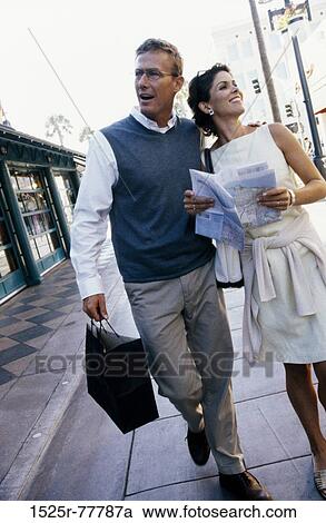 Stock Image - people, walking, couple, map, street, outdoors, tourism. Fotosearch