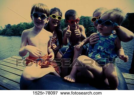 people, water, sitting, sunglasses, playful, gesturing View Large Photo Image Stock Photo - people, water, sitting, sunglasses, playful, gesturing. Fotosearch