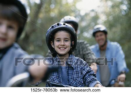 Stock Image - Portrait of a daughter cycling with her parents. Fotosearch