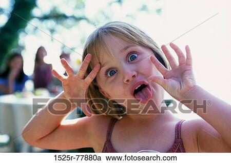 Portrait of a girl making a funny face View Large Photo Image Stock Image - Portrait of a girl making a funny face. Fotosearch
