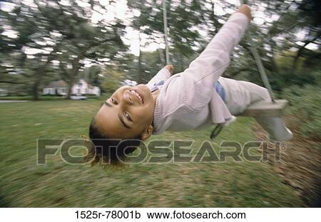 Portrait of a girl swinging on a swing View Large Photo Image Stock Image - Portrait of a girl swinging on a swing. Fotosearch