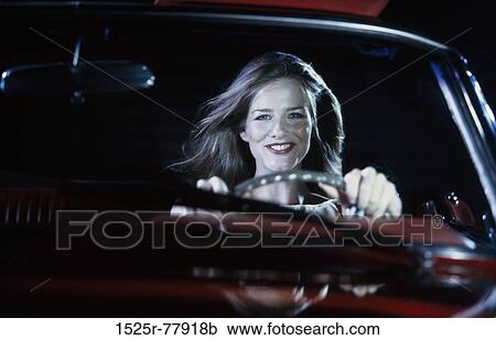 Portrait of a young woman driving a car View Large Photo Image Stock Image - Portrait of a young woman driving a car. Fotosearch