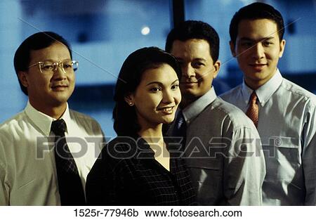 Portrait of three businessmen and a businesswoman smiling in an office View Large Photo Image Stock Image - Portrait of three businessmen and a businesswoman smiling in an office. Fotosearch